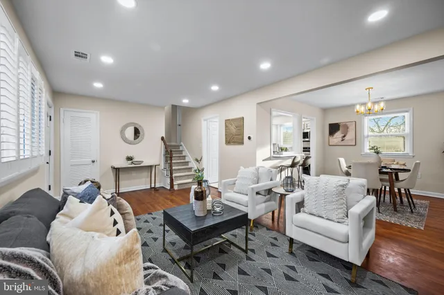a living room with furniture and wooden floor