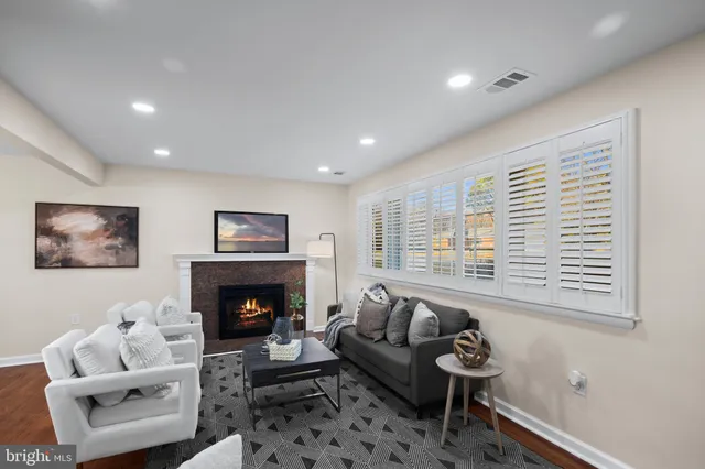 a living room with furniture window and a fireplace
