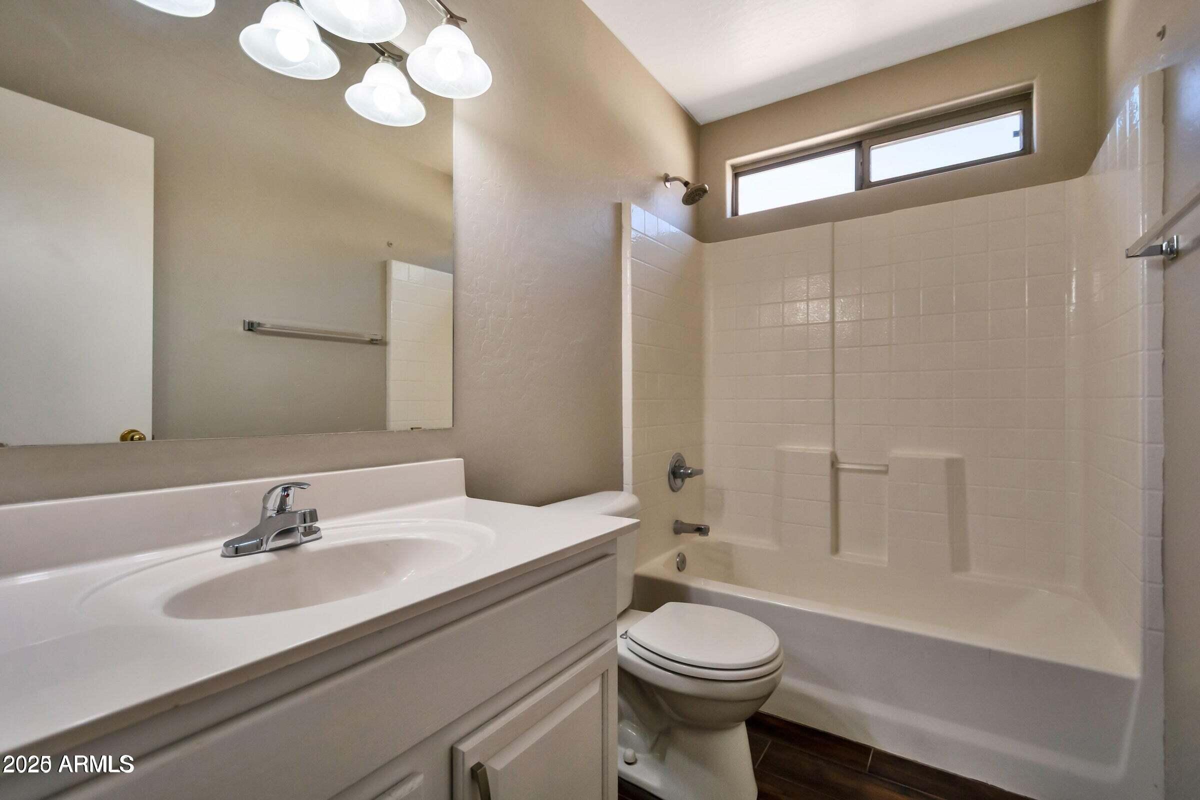 1228 East Elm Road San Tan Valley, AZ 85140 - Photo 11 of 13 a bathroom with a sink a toilet and shower