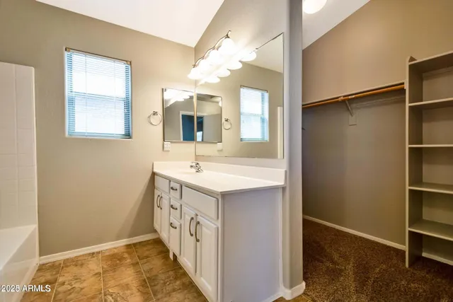 a bathroom with a sink a mirror and a shower