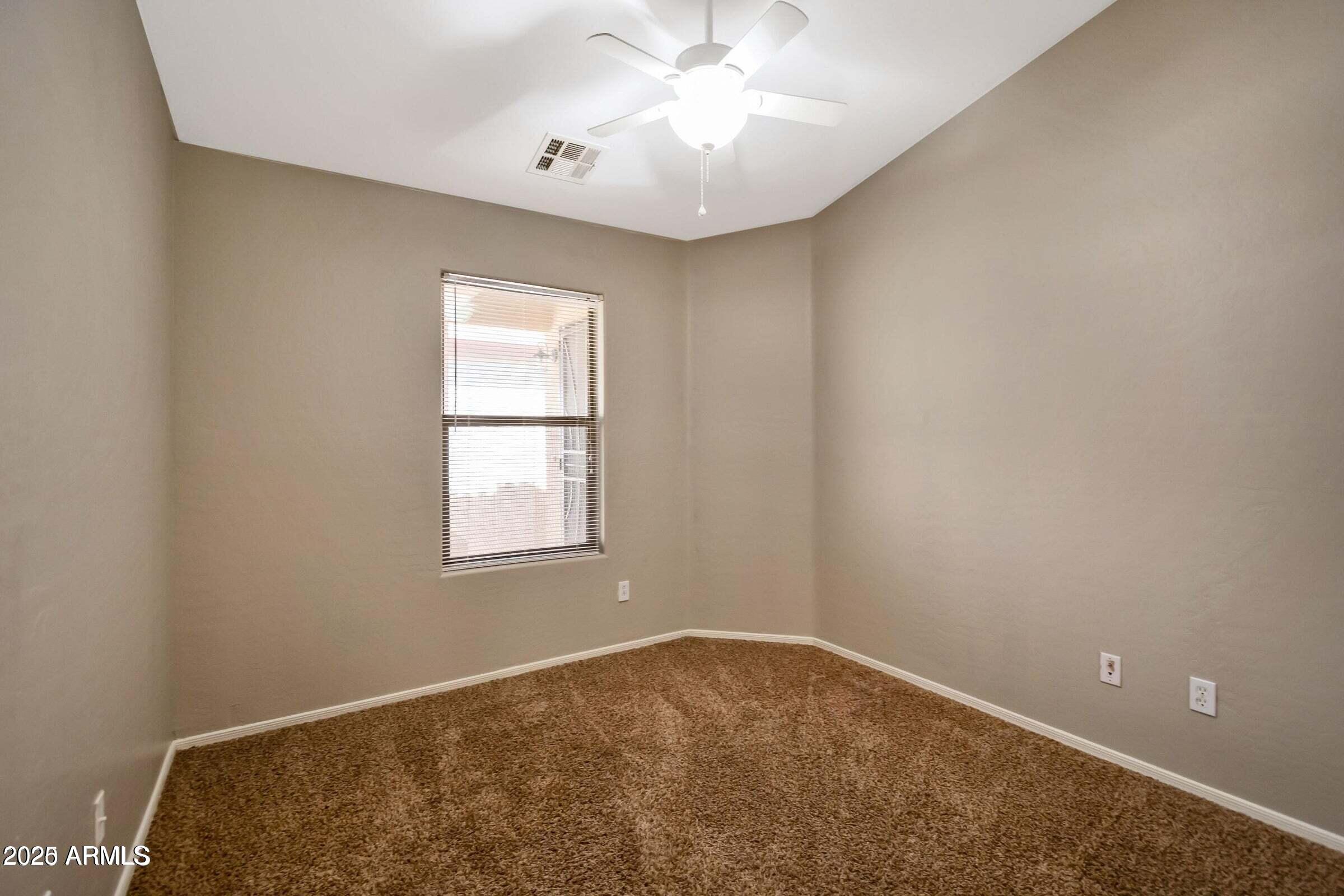 1228 East Elm Road San Tan Valley, AZ 85140 - Photo 10 of 13 an empty room with a window