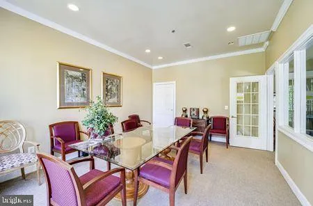 a view of a dining room with furniture and a potted plant