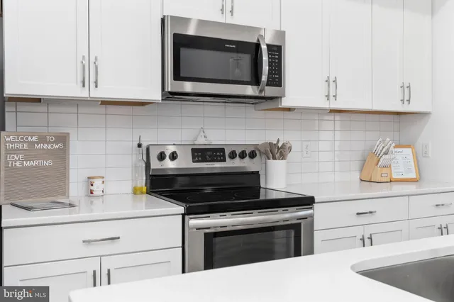 a kitchen with a sink and a refrigerator