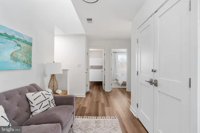 a bedroom with a bed and white cabinets