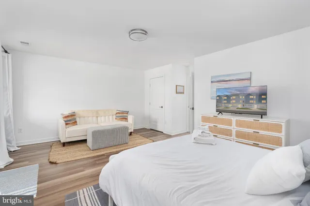 a bathroom with a granite countertop toilet a sink and a mirror
