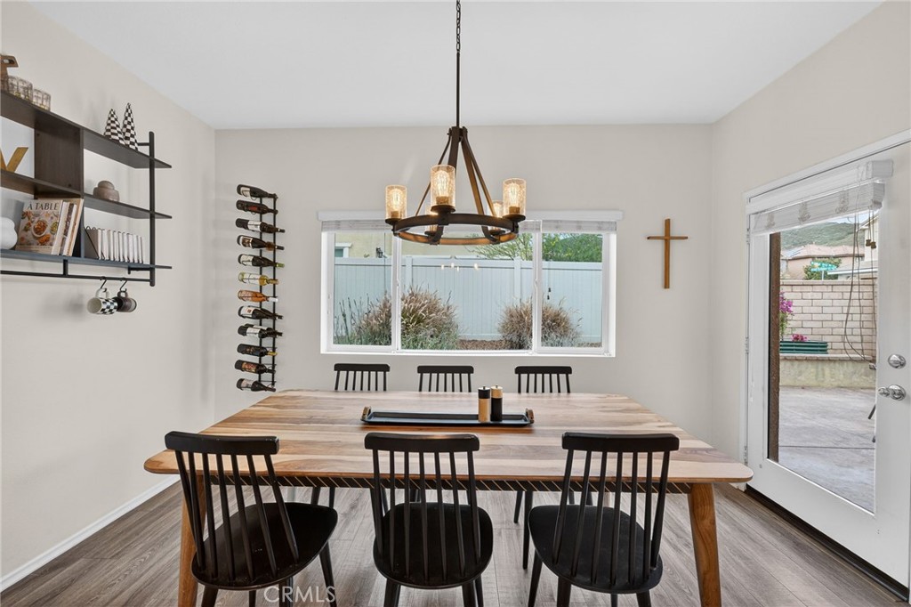 35462 Brown Galloway Lane Fallbrook, CA 92028 - Photo 16 of 63 a view of a dining room with furniture window and wooden floor