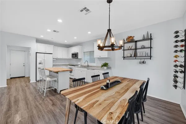 a bedroom with a large bed and a wooden floor