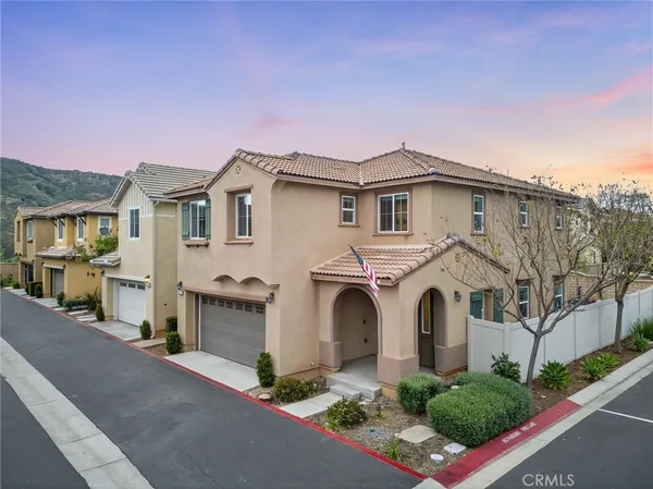 a view of a hallway with wooden floor and furniture