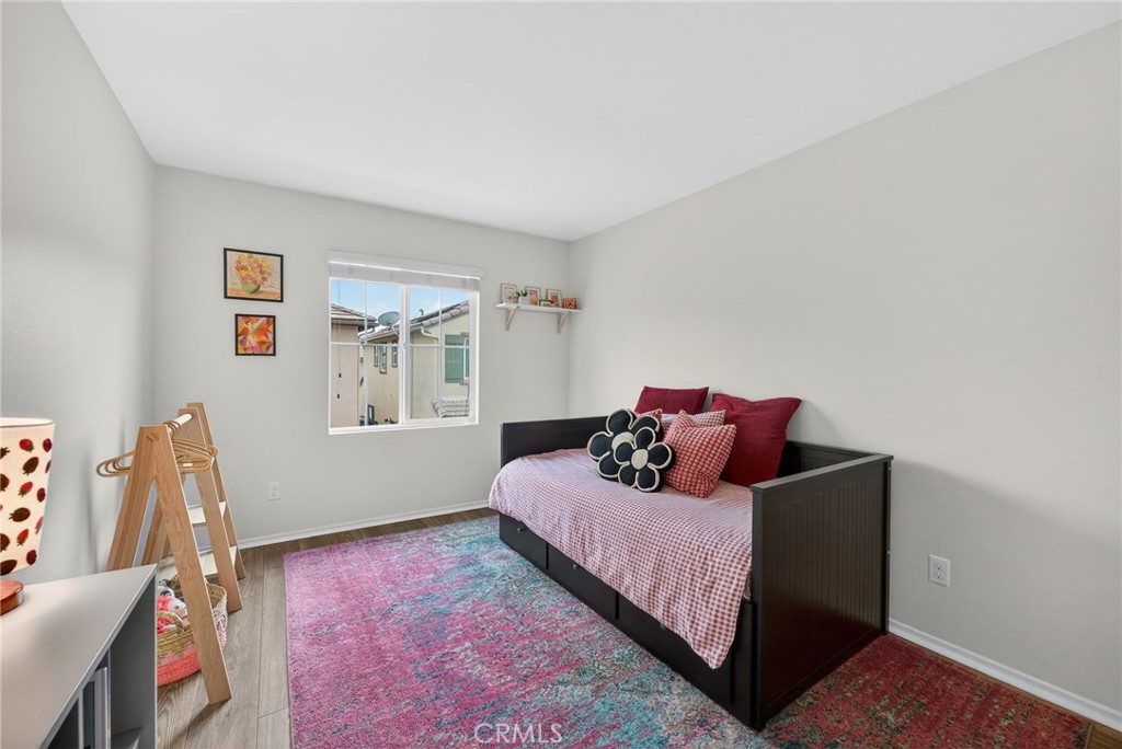 35462 Brown Galloway Lane Fallbrook, CA 92028 - Photo 26 of 63 a bed sitting in a bedroom next to a window with wooden floor