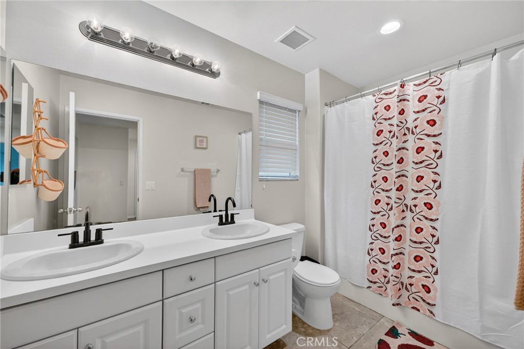 35462 Brown Galloway Lane Fallbrook, CA 92028 - Photo 29 of 63 a bathroom with a double vanity sink mirror and toilet