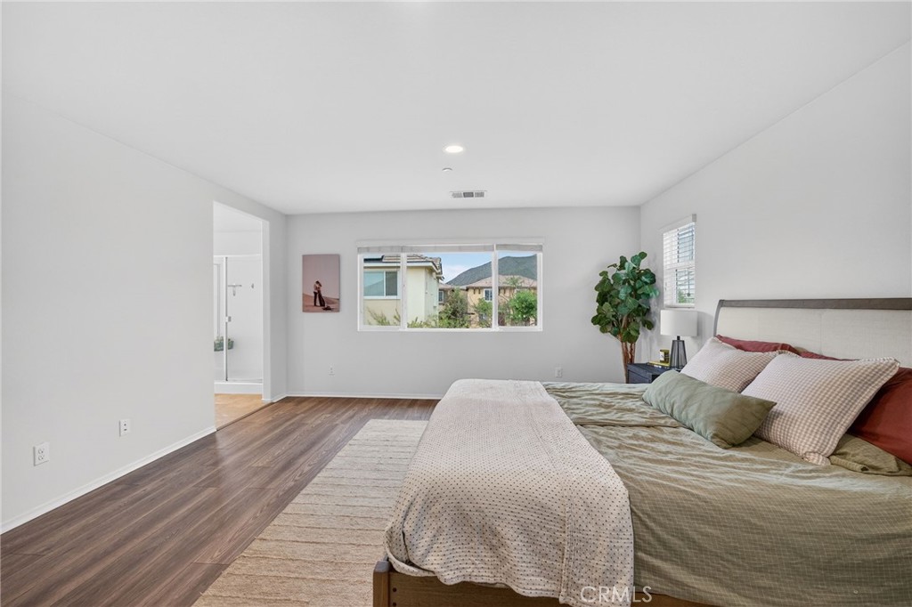 35462 Brown Galloway Lane Fallbrook, CA 92028 - Photo 37 of 63 a bedroom with a large bed and a potted plant
