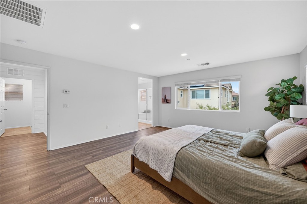 35462 Brown Galloway Lane Fallbrook, CA 92028 - Photo 38 of 63 a bedroom with a large bed and a wooden floor