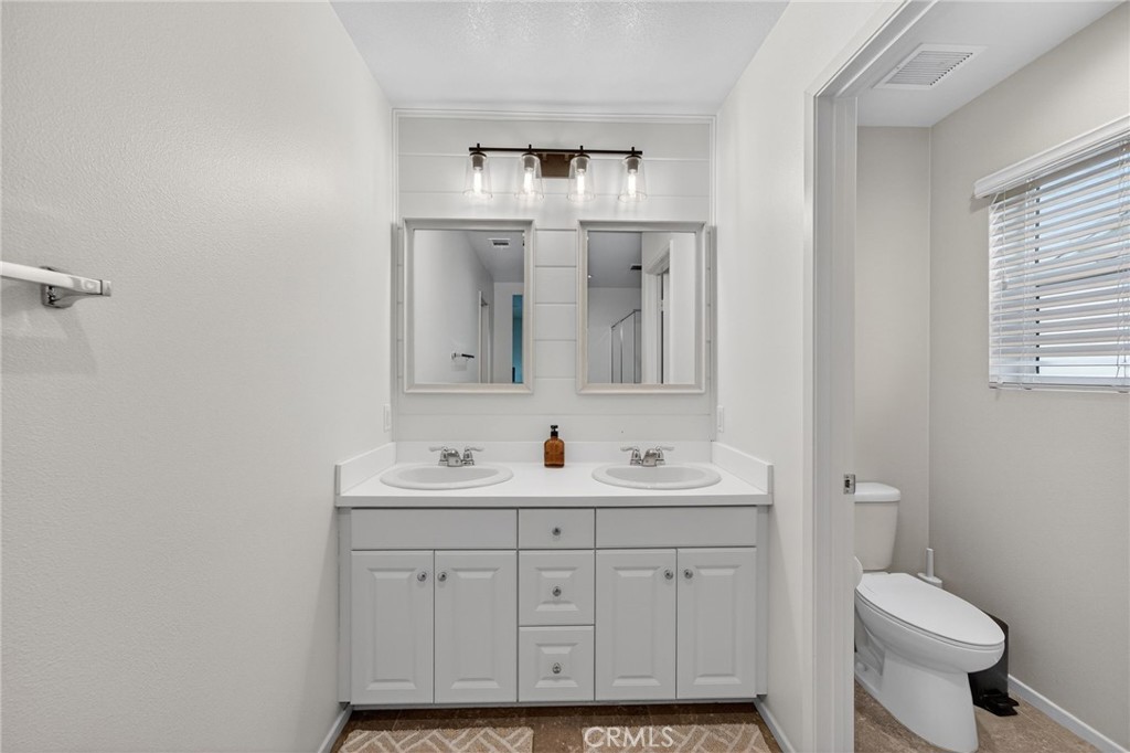 35462 Brown Galloway Lane Fallbrook, CA 92028 - Photo 41 of 63 a bathroom with a toilet sink and mirror