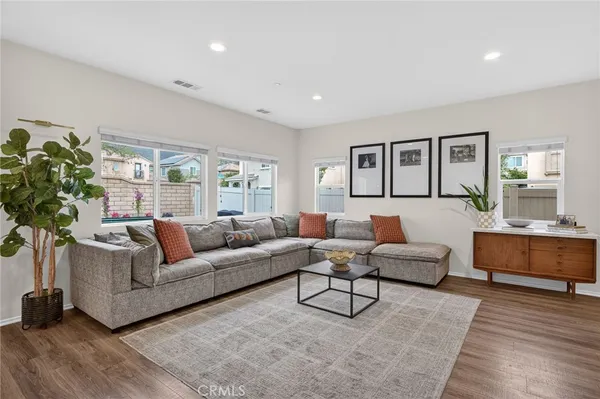 a view of a hallway with wooden floor and entryway