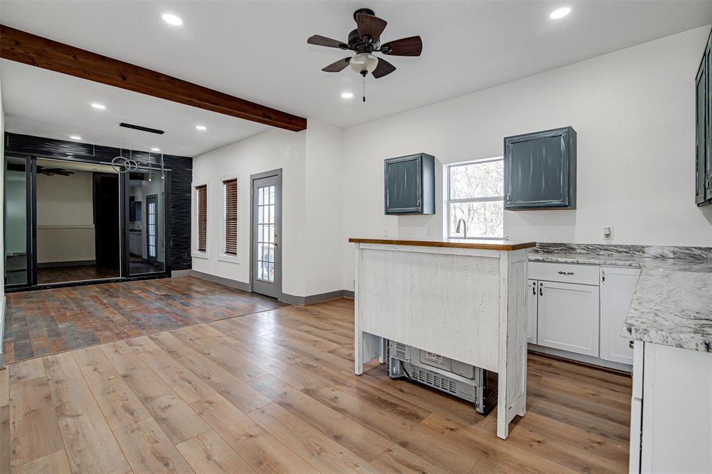 801 South Hampton Road Crowley, TX 76036 - Photo 15 of 26 Kitchen featuring ceiling fan, recessed lighting, light wood-style floors, beamed ceiling, and white cabinetry