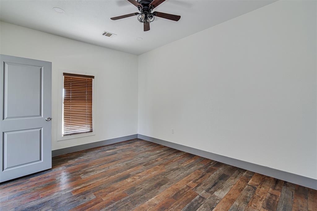 801 South Hampton Road Crowley, TX 76036 - Photo 16 of 26 Spare room featuring dark wood-type flooring and ceiling fan