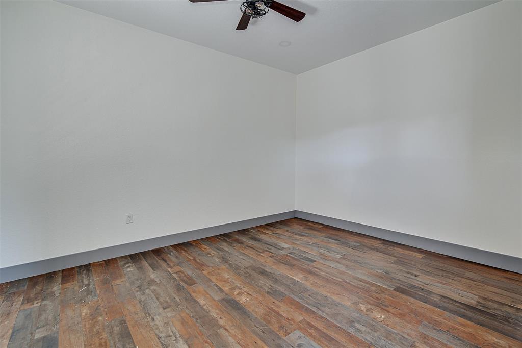 801 South Hampton Road Crowley, TX 76036 - Photo 17 of 26 Spare room featuring dark wood-style flooring and ceiling fan