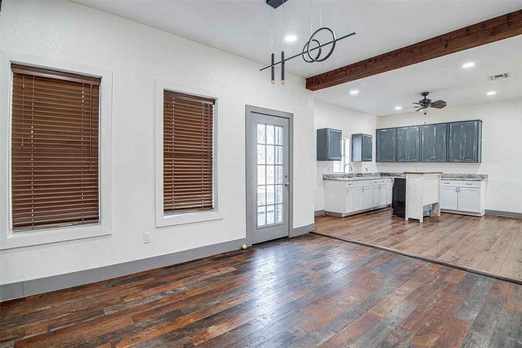 801 South Hampton Road Crowley, TX 76036 - Photo 26 of 26 Kitchen featuring a ceiling fan, dark wood-style flooring, light countertops, beamed ceiling, and open floor plan