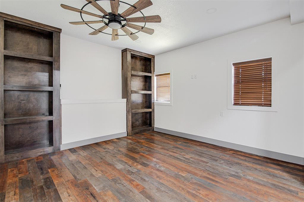 801 South Hampton Road Crowley, TX 76036 - Photo 9 of 26 media room/living room featuring dark wood-type flooring, a ceiling fan, and built in features