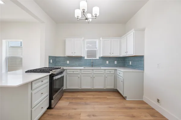 a kitchen with stainless steel appliances granite countertop a stove and a sink