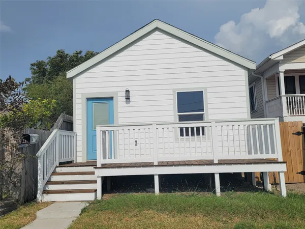 a view of a house with a yard and stairs