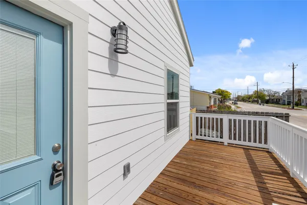 a view of a balcony with wooden floor