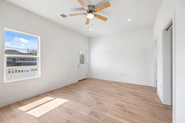 wooden floor in an empty room with a window