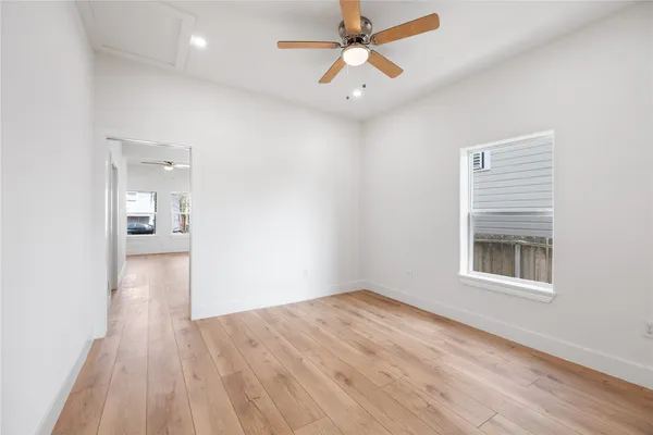 wooden floor in an empty room with a window