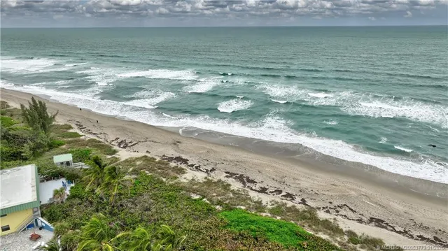 a kitchen with stainless steel appliances a wooden floor