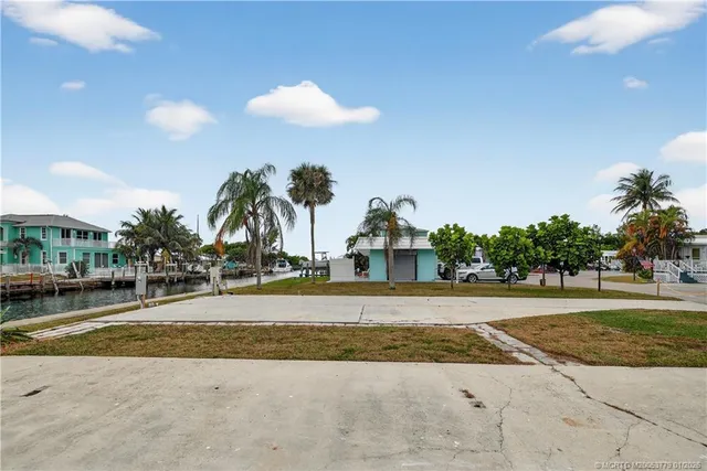 a view of a house with a swimming pool and a yard