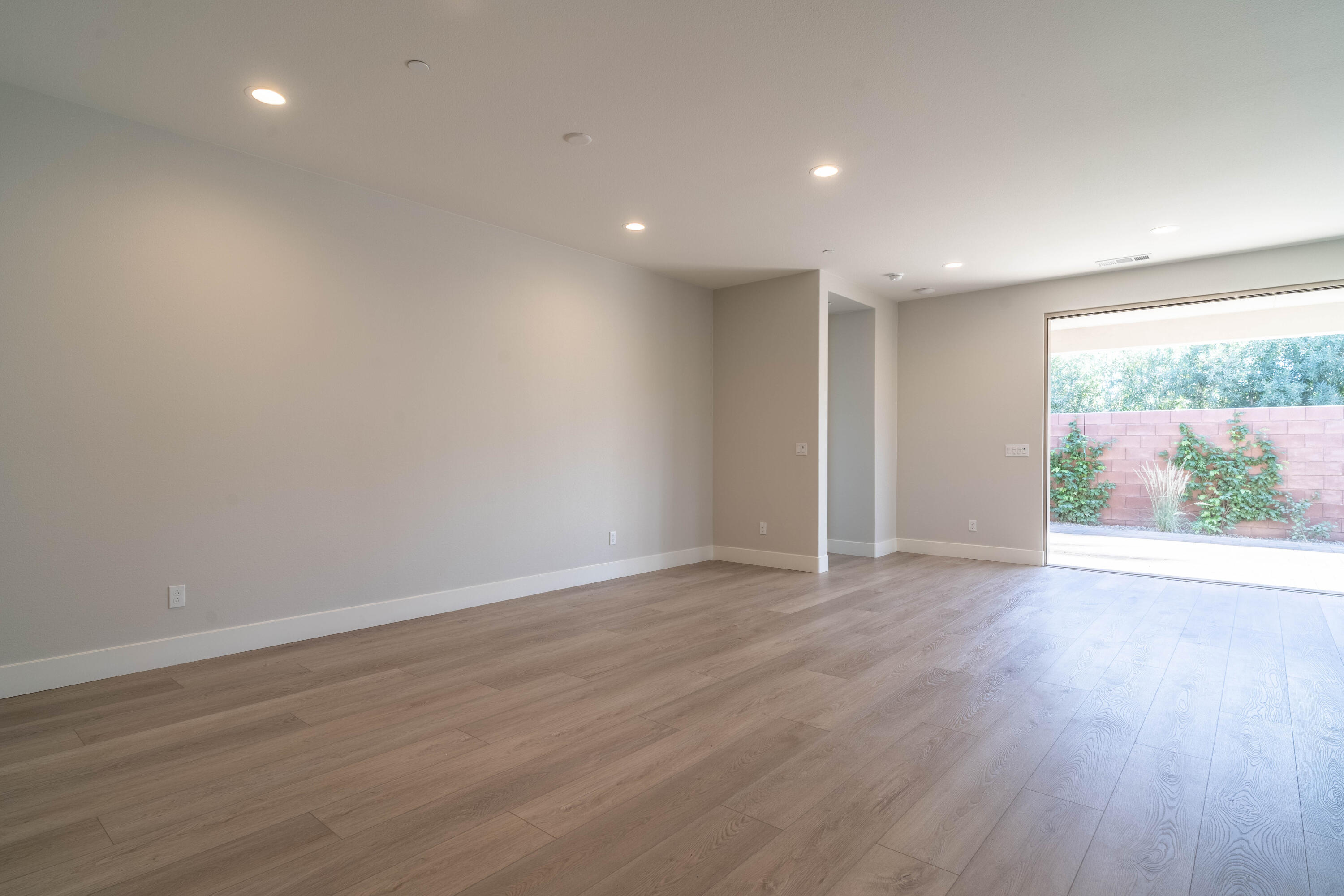 51580 Whiptail Drive Indio, CA 92201 - Photo 12 of 28 an empty room with wooden floor and windows