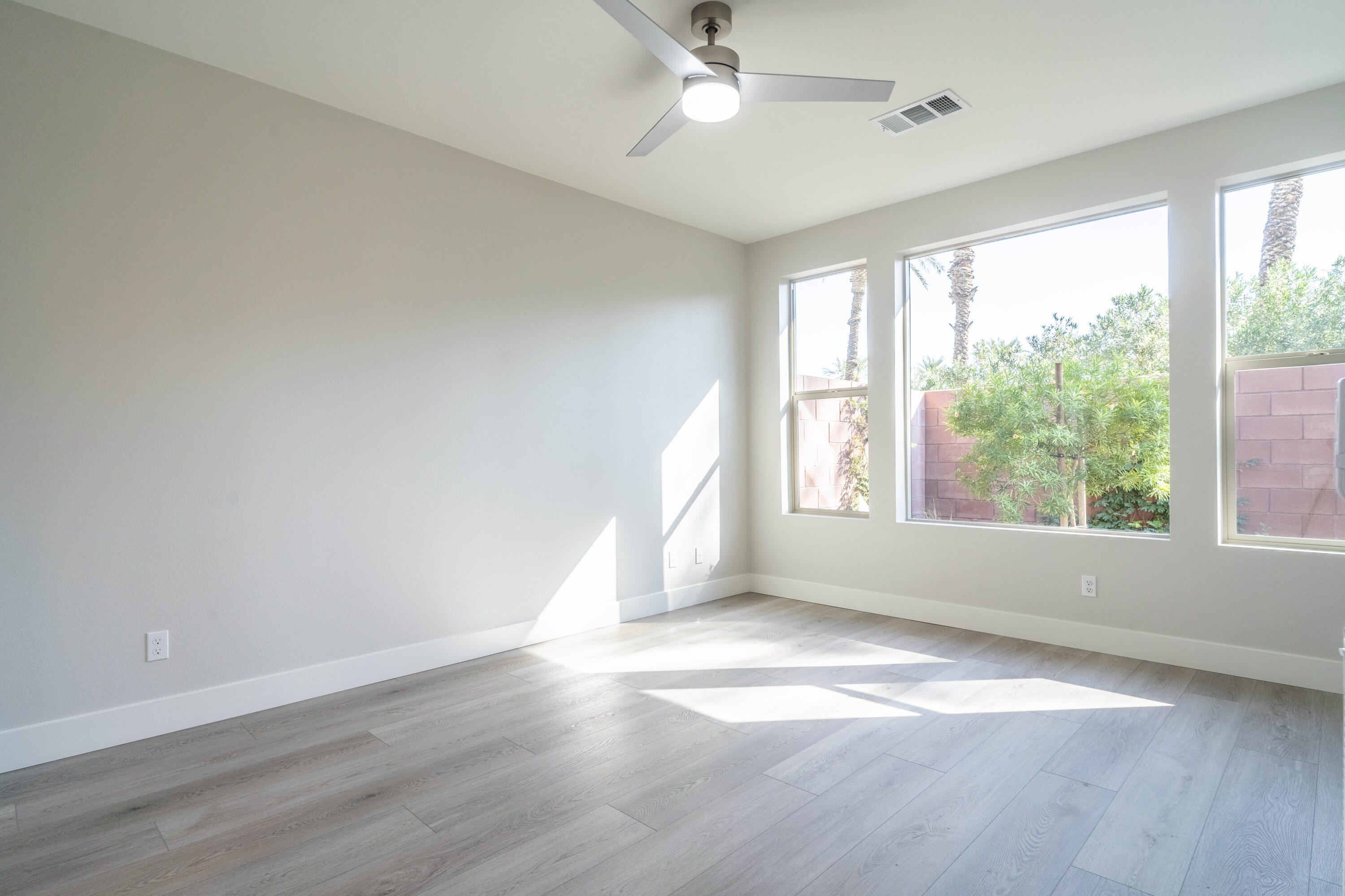 51580 Whiptail Drive Indio, CA 92201 - Photo 13 of 28 a view of empty room with wooden floor and fan