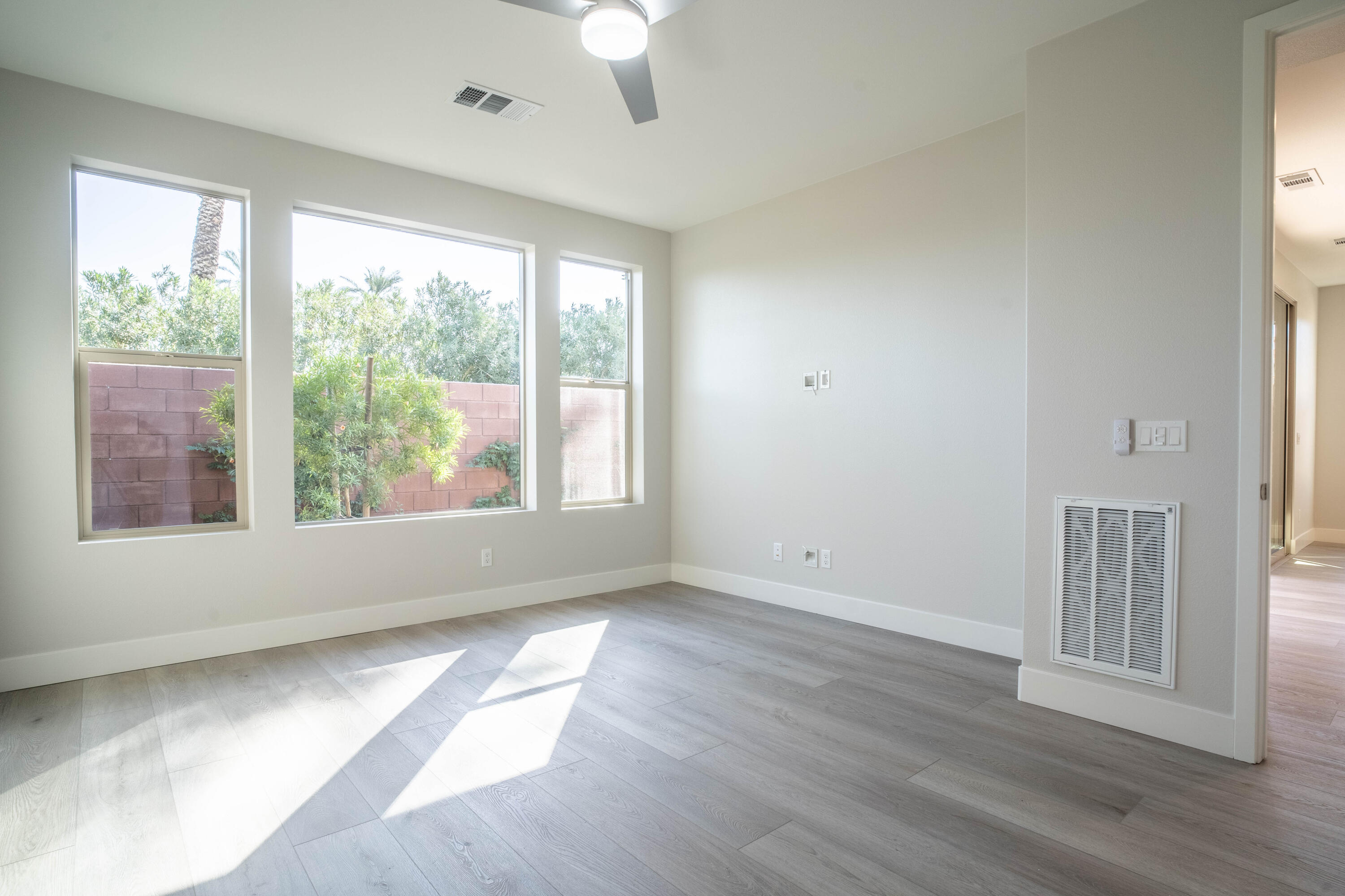51580 Whiptail Drive Indio, CA 92201 - Photo 15 of 28 a view of empty room with wooden floor and fan