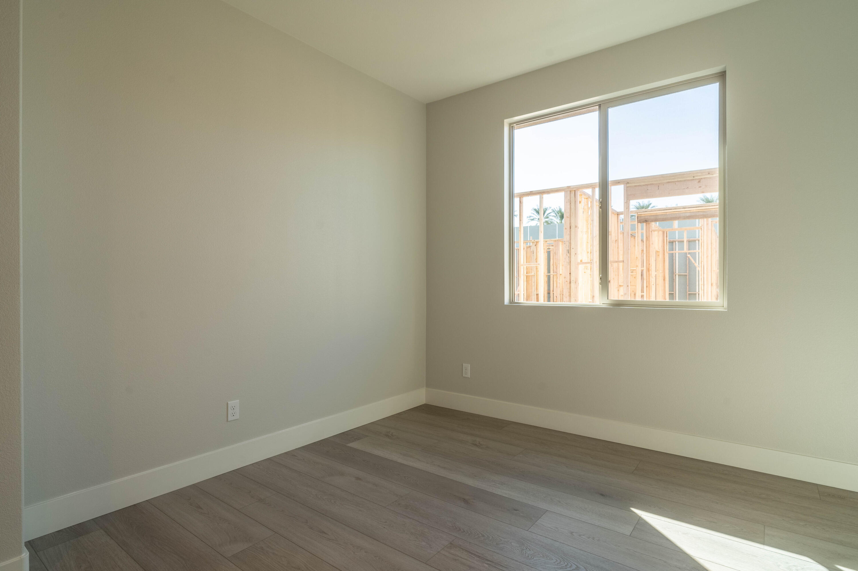 51580 Whiptail Drive Indio, CA 92201 - Photo 18 of 28 an empty room with wooden floor and windows
