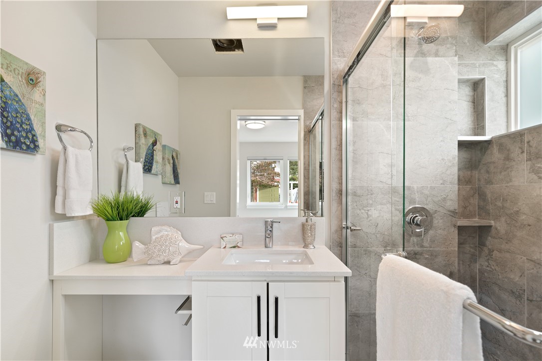 3638 36th Avenue South, Unit D Seattle, WA 98144 - Photo 11 of 30 a bathroom with a bathtub sink and mirror