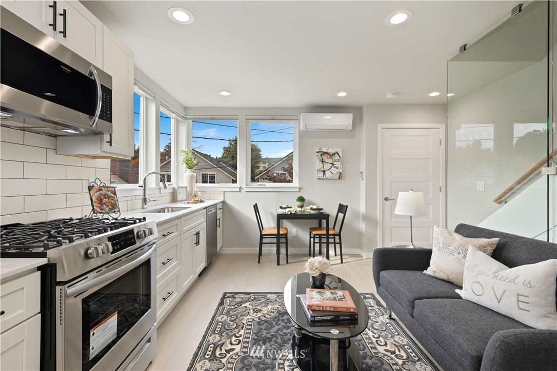 3638 36th Avenue South, Unit D Seattle, WA 98144 - Photo 2 of 30 a living room with furniture and a flat screen tv