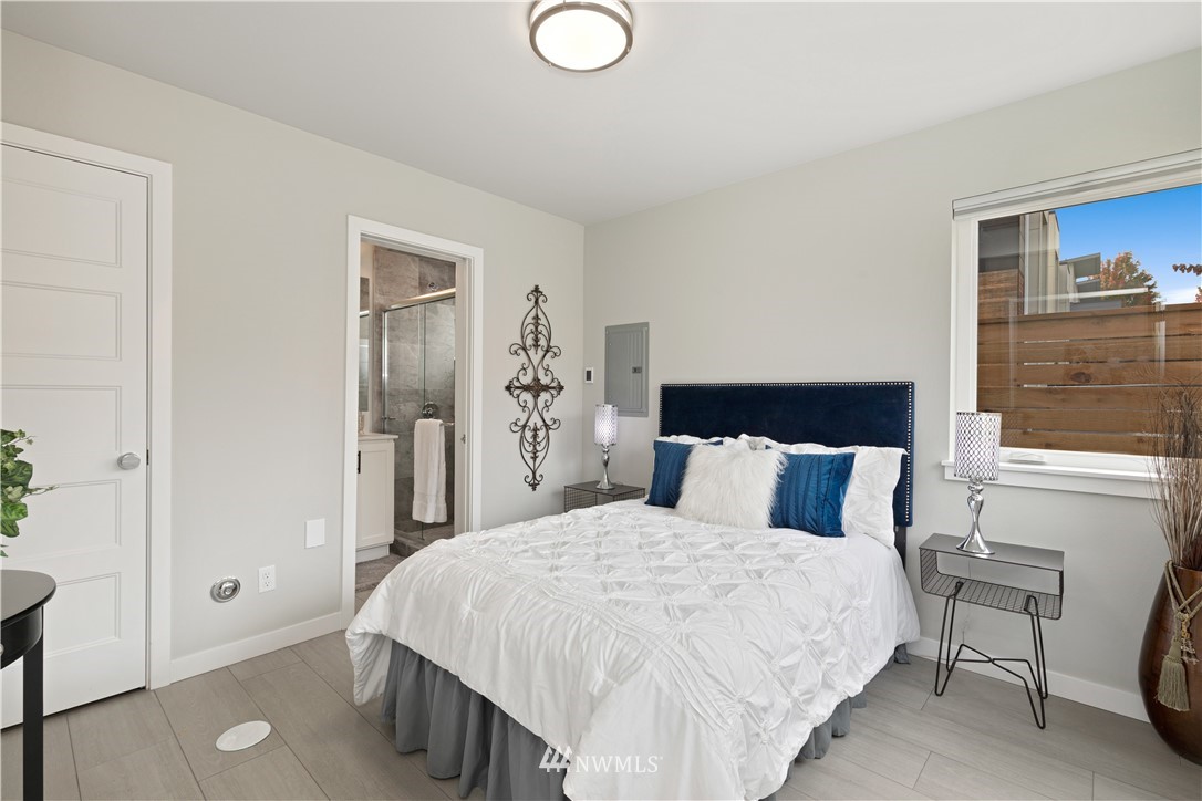 3638 36th Avenue South, Unit D Seattle, WA 98144 - Photo 8 of 30 a bedroom with a bed and closet with mirror