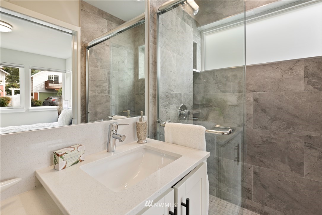 3638 36th Avenue South, Unit D Seattle, WA 98144 - Photo 9 of 30 a bathroom with a sink and mirror