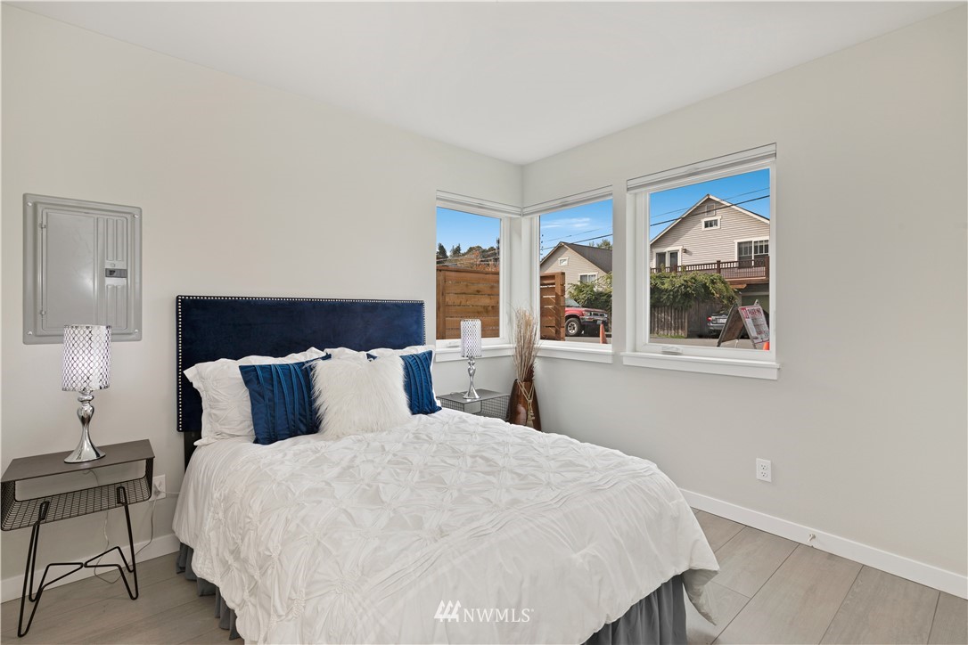 3638 36th Avenue South, Unit D Seattle, WA 98144 - Photo 10 of 30 a bedroom with a large bed and a window