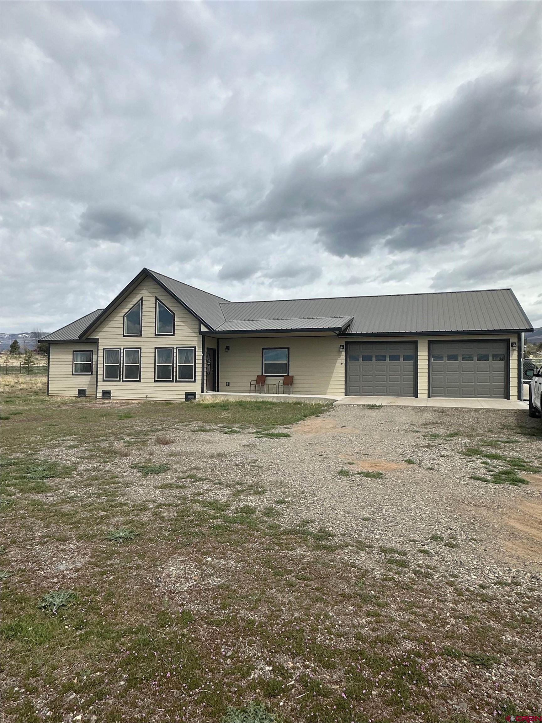 18485 2375th Road Cedaredge, CO 81413 - Photo 1 of 3 a front view of a house with garden