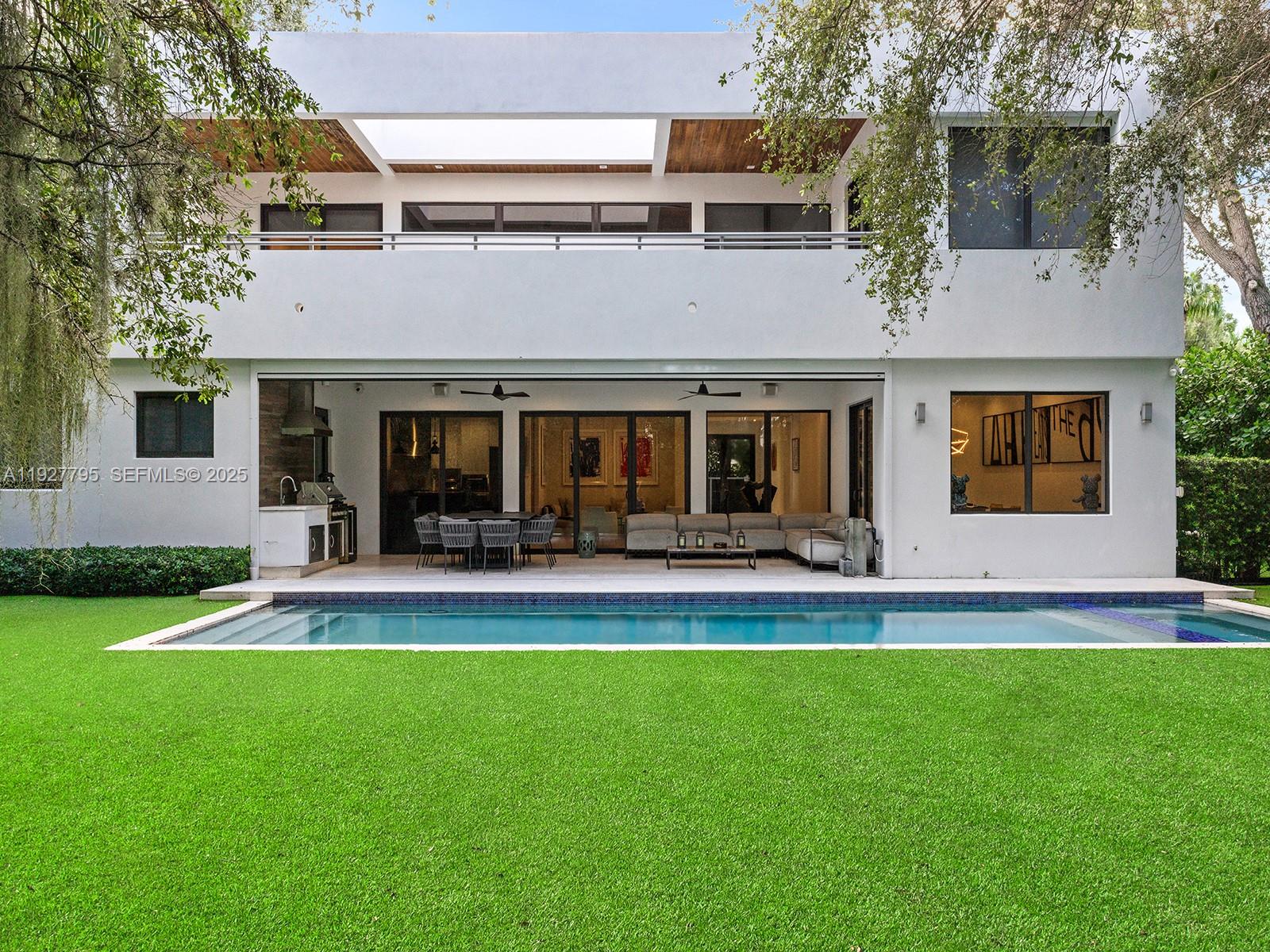 a view of a house with a yard and a patio
