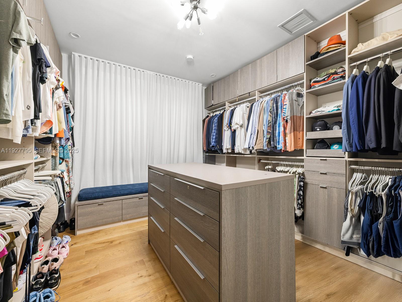 1760 Chucunantah Road Miami, FL 33133 - Photo 12 of 21 a view of walk in closet with clothes and shoes