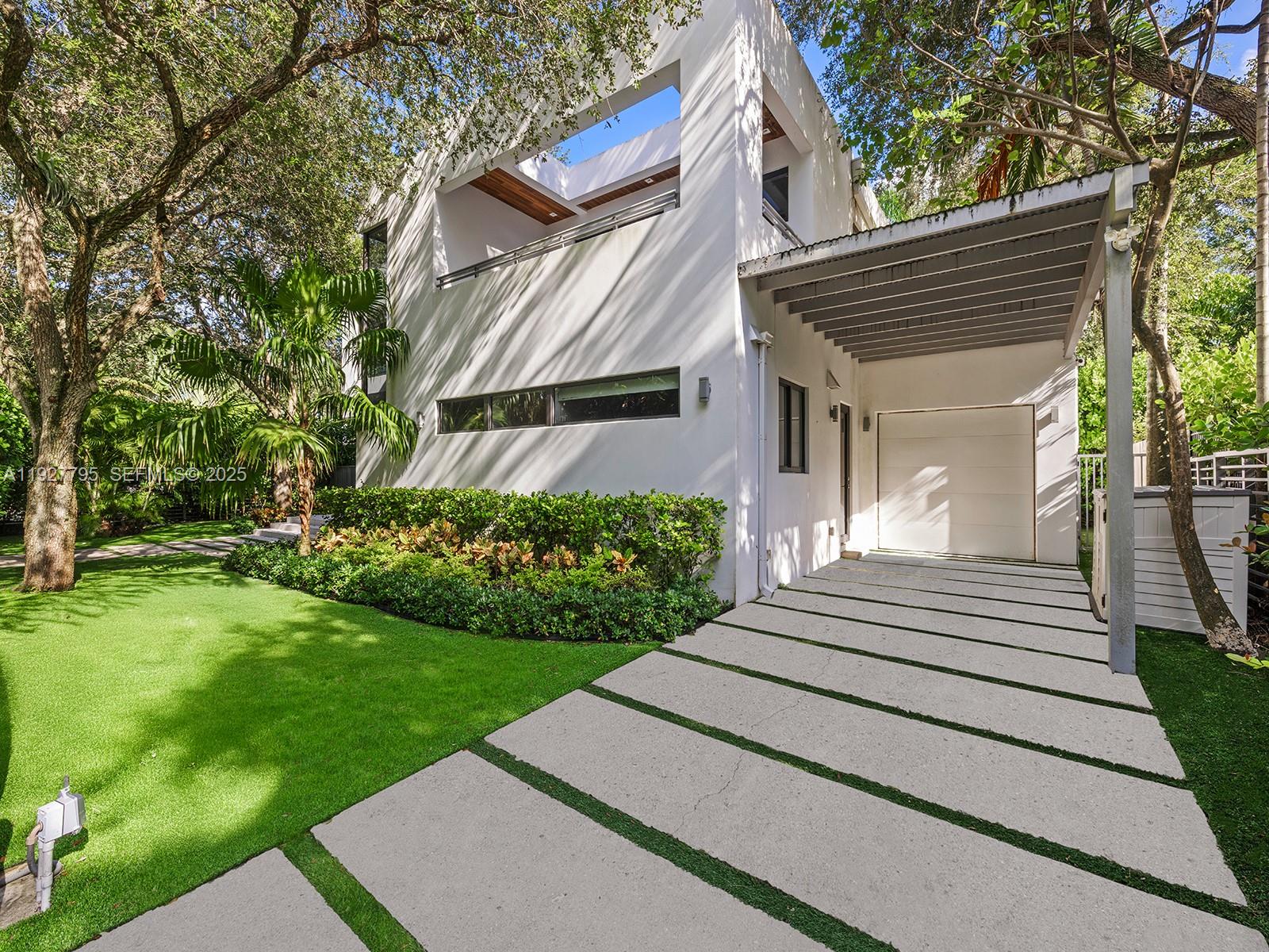 1760 Chucunantah Road Miami, FL 33133 - Photo 19 of 21 a view of a house with a yard
