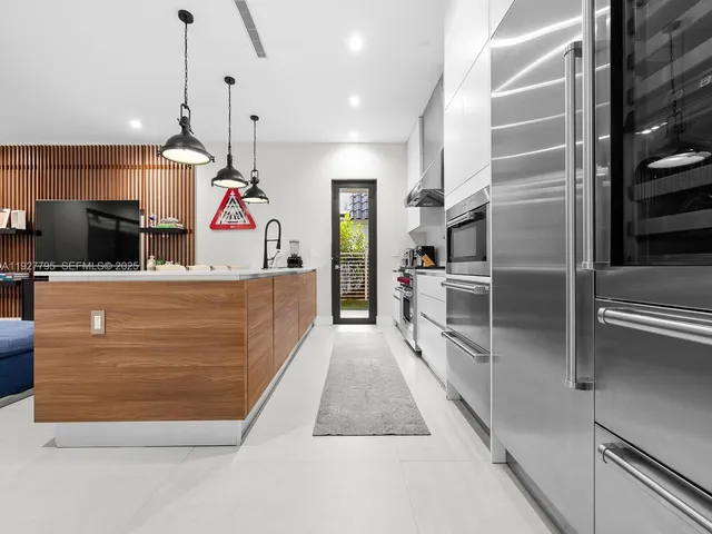 a kitchen with refrigerator and window