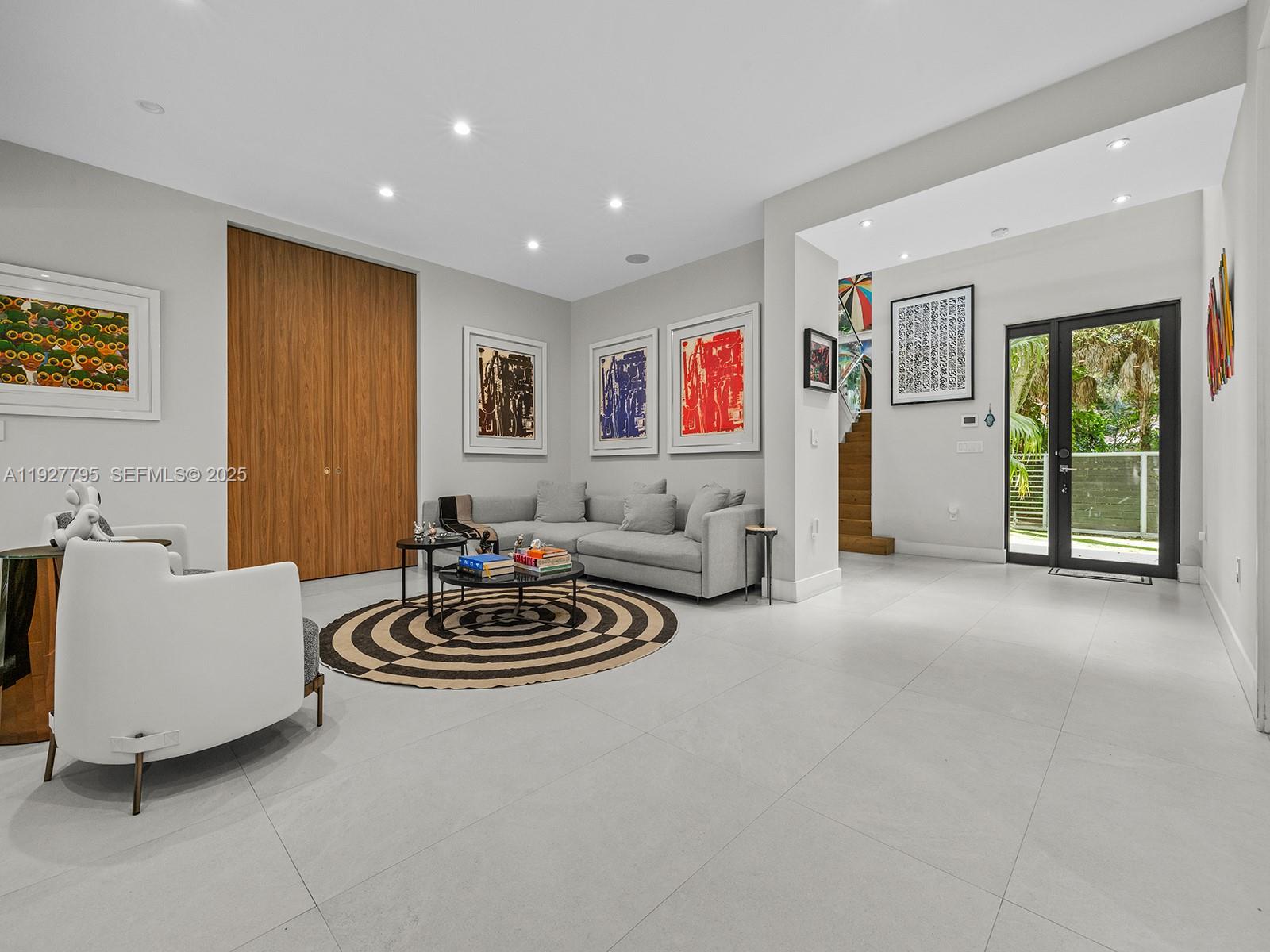 1760 Chucunantah Road Miami, FL 33133 - Photo 5 of 21 a living room with furniture and a large window