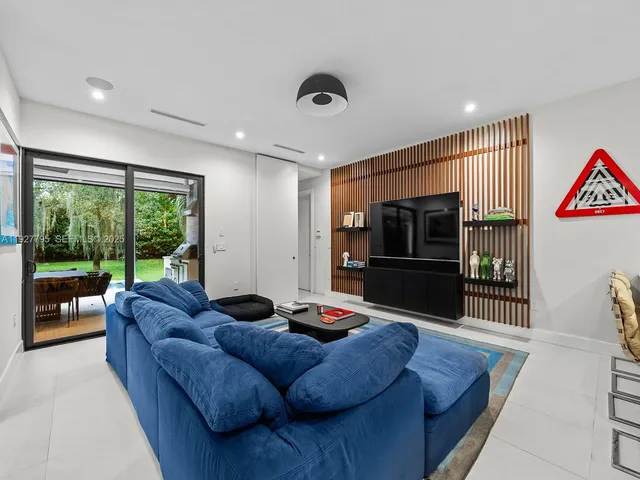 a living room with furniture tv and a large window