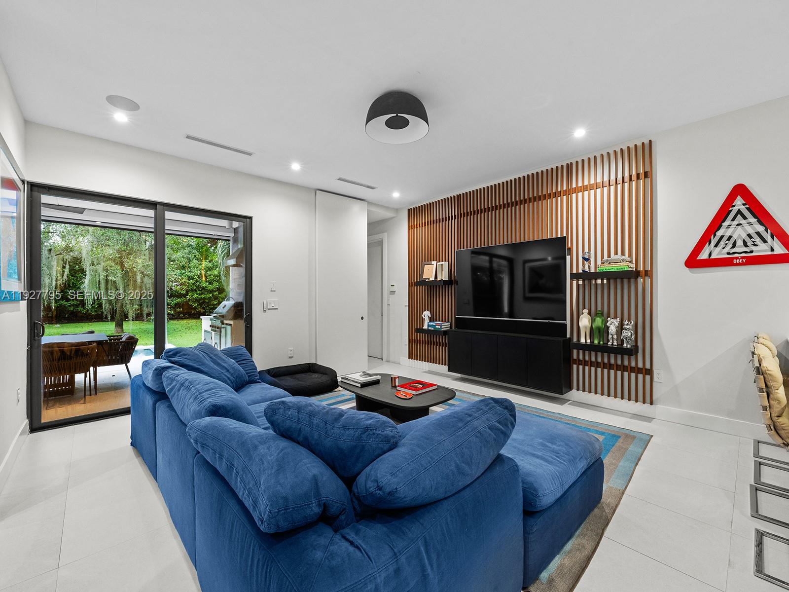 1760 Chucunantah Road Miami, FL 33133 - Photo 9 of 21 a living room with furniture tv and a large window