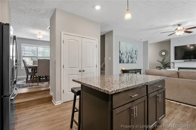 a living room with granite countertop furniture and a flat screen tv
