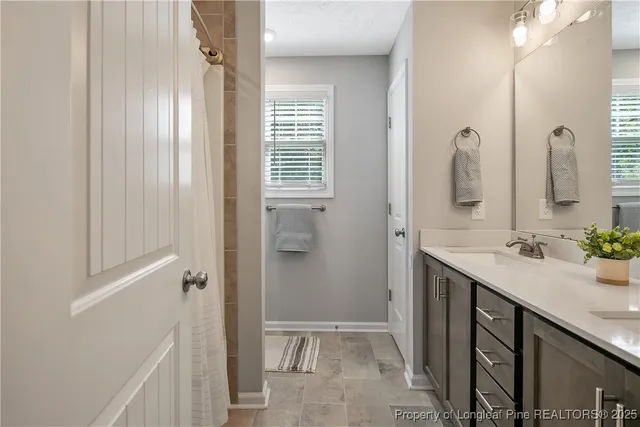 a bathroom with double sink and a mirror
