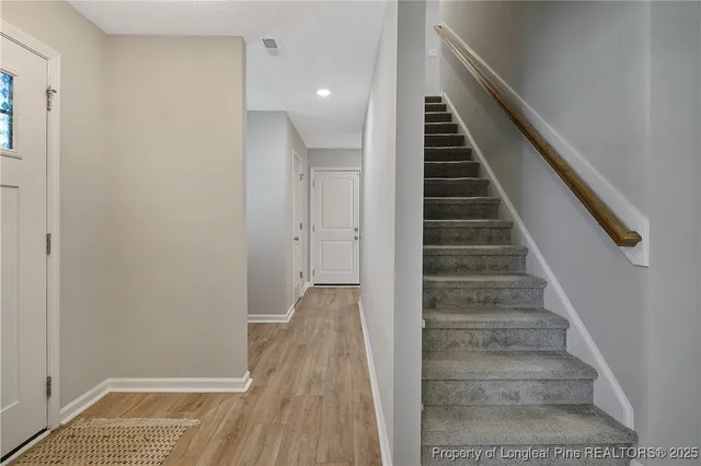 a view of entryway and gallery with wooden floor